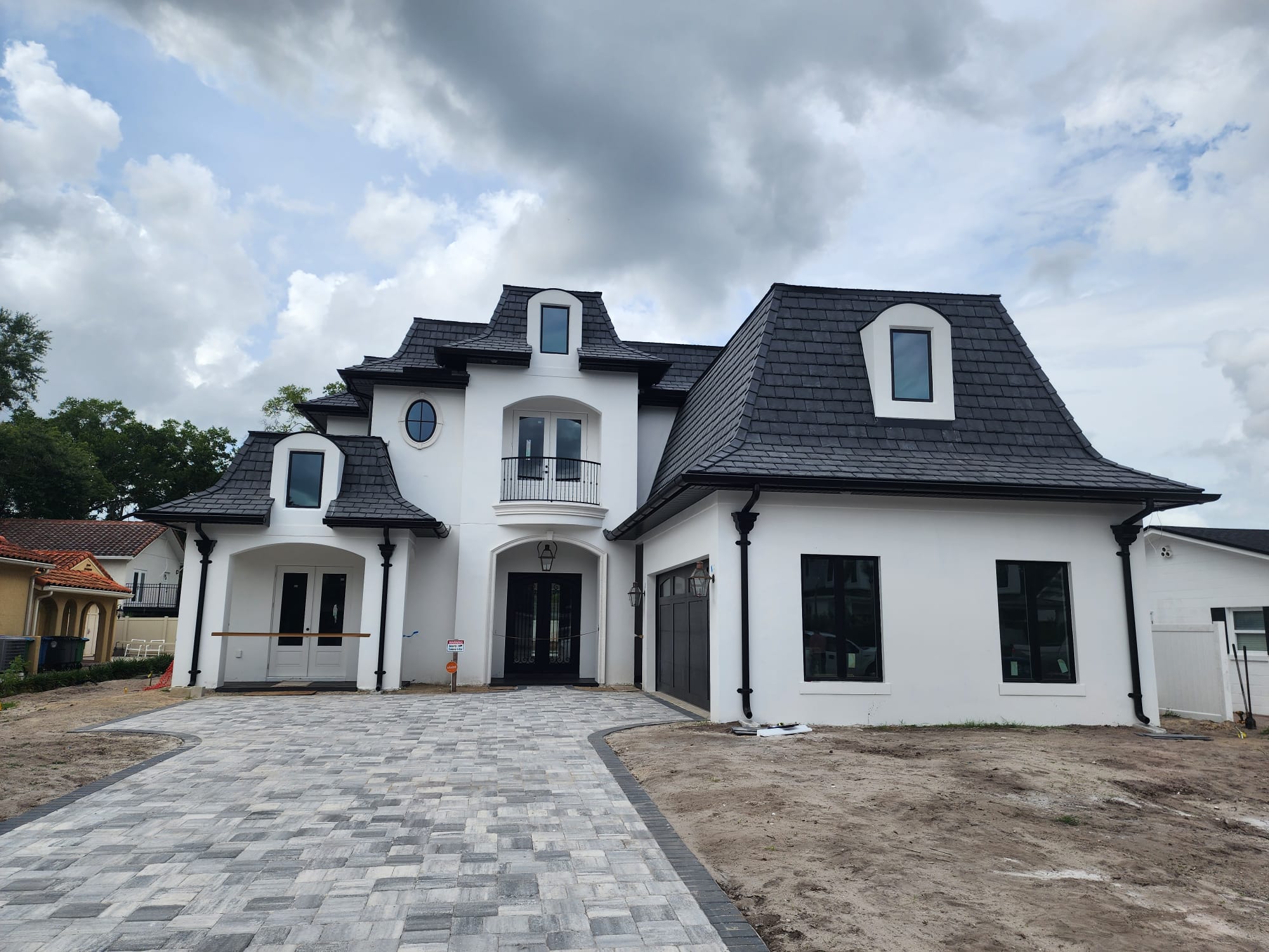 Modern French-style home with foam window trims and architectural details